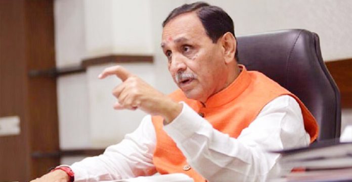 gujarat cm tests positive for coronavirus after fainting in rally