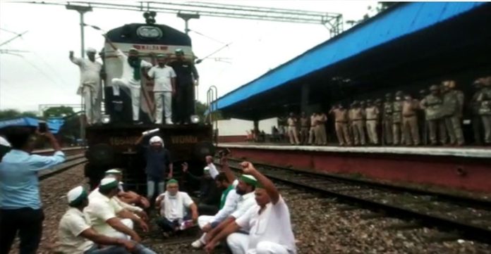 agitating farmers stop trains at modinagar railway station in uttar pradesh