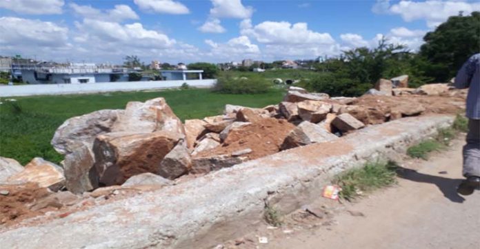 Banks of Mir Alam Lake filled with fresh dumping of debris