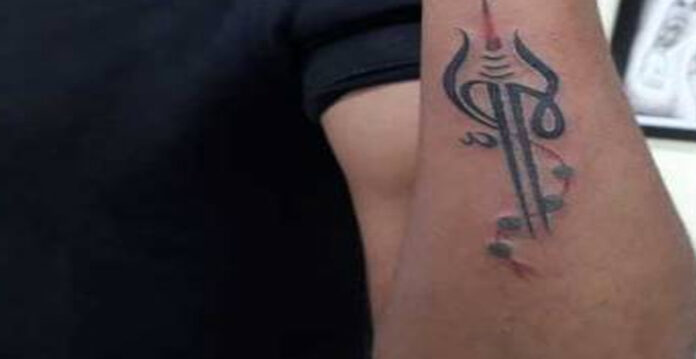 trishul tattoo on left forearm